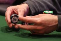 A player fiddles with chips during the World Series of Poker main event at Horseshoe Convention ...