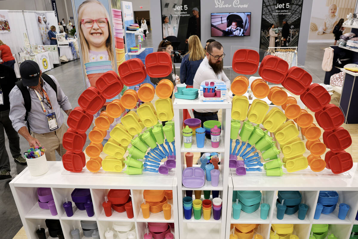 Conventioneers check out colorful children’s tableware made from recycled materials duri ...