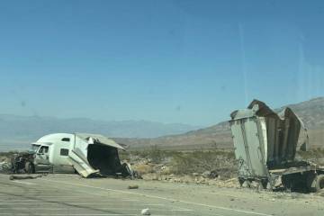 The truck and trailer involved in the accident. Collision with the stone building resulted in t ...