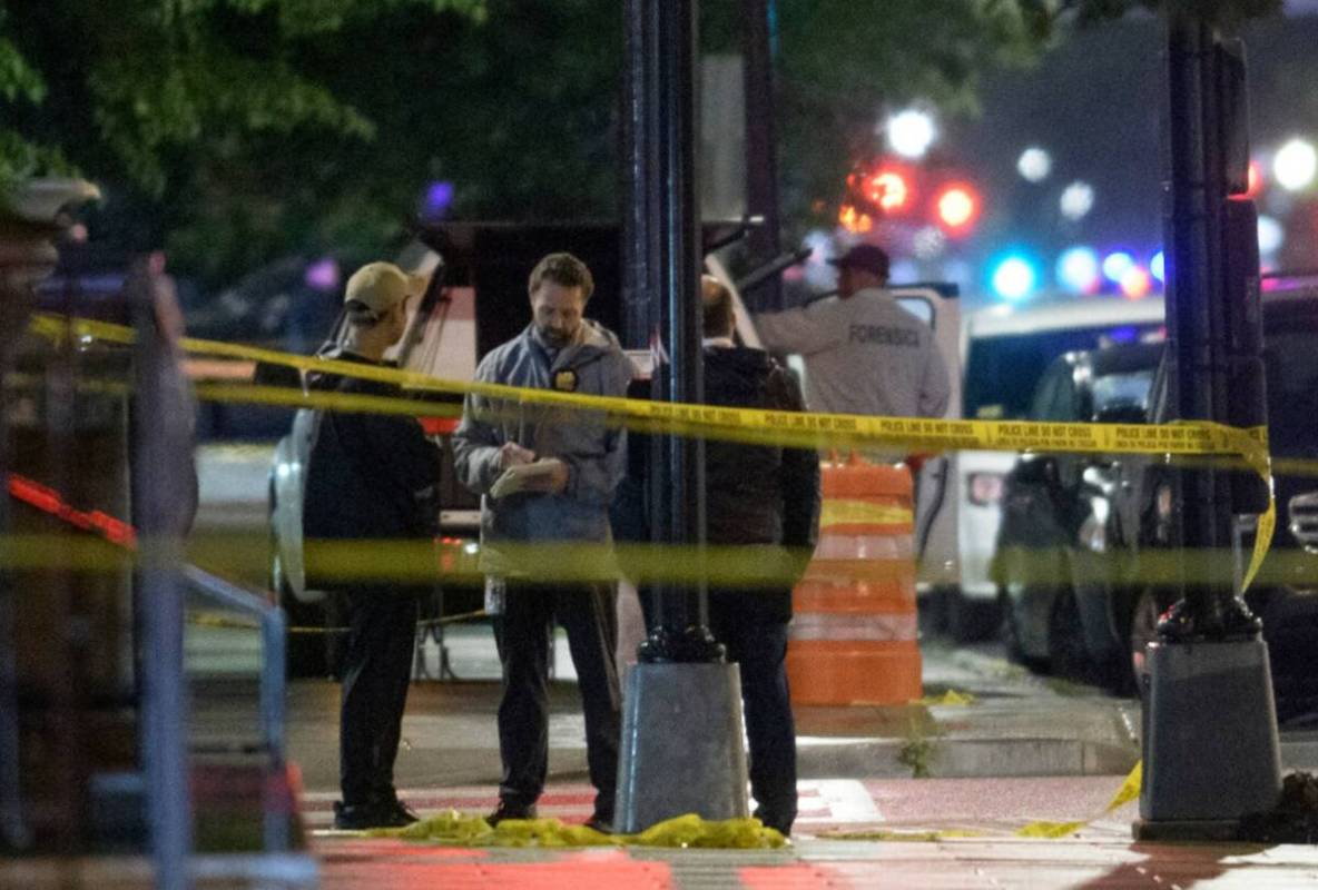 Law enforcement work the scene after two staff members of the Israeli Embassy in Washington wer ...