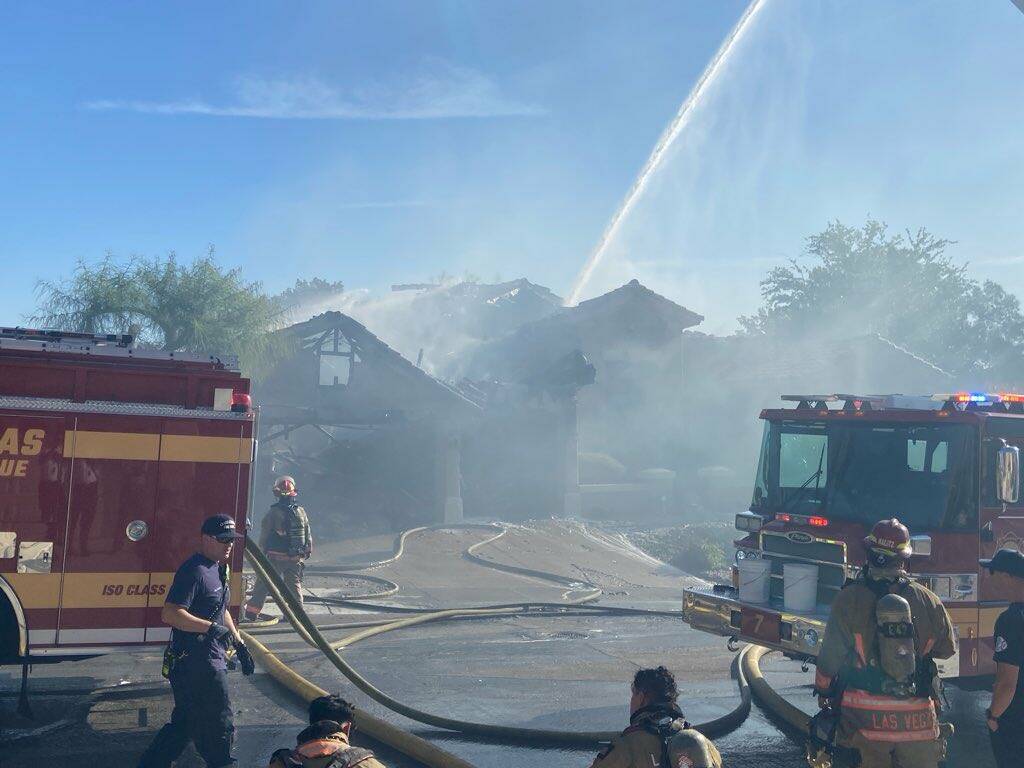 Las Vegas Fire & Rescue crews work to contain a house fire Thursday, May 22, 2025, in the 10000 ...