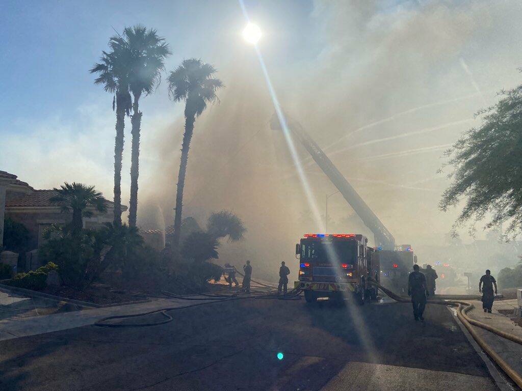 Las Vegas Fire & Rescue crews work to contain a house fire Thursday, May 22, 2025, in the 10000 ...
