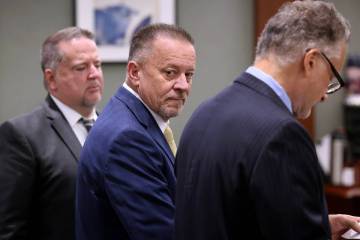 Defense attorney Gary Guymon, center, accused of sex trafficking and plotting with felons to ki ...