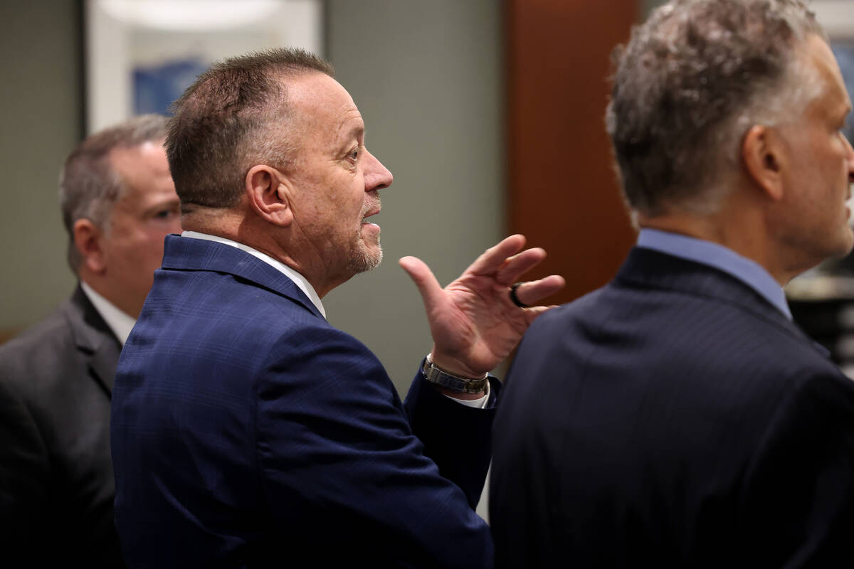 Defense attorney Gary Guymon, center, accused of sex trafficking and plotting with felons to ki ...