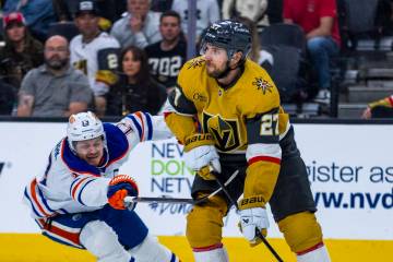 Golden Knights defenseman Shea Theodore (27) looks to pass as Edmonton Oilers center Mattias Ja ...