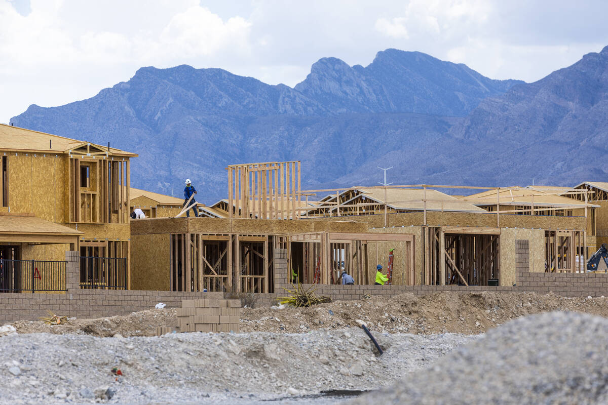 Workers complete framing and walls on new home construction about Skye Canyon on Wednesday, Jul ...