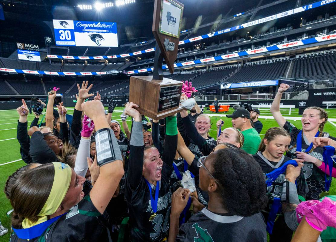 Palo Verde linebacker Madeline West (36) holds up the winning trophy with teammates after their ...