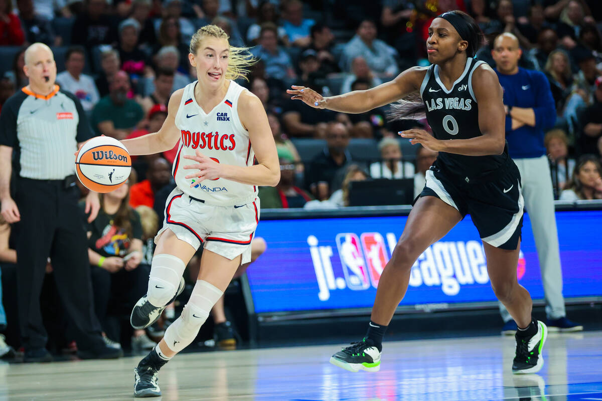 Washington Mystics guard Lucy Olsen (33) sticks her tongue out as she dribbles the ball while A ...