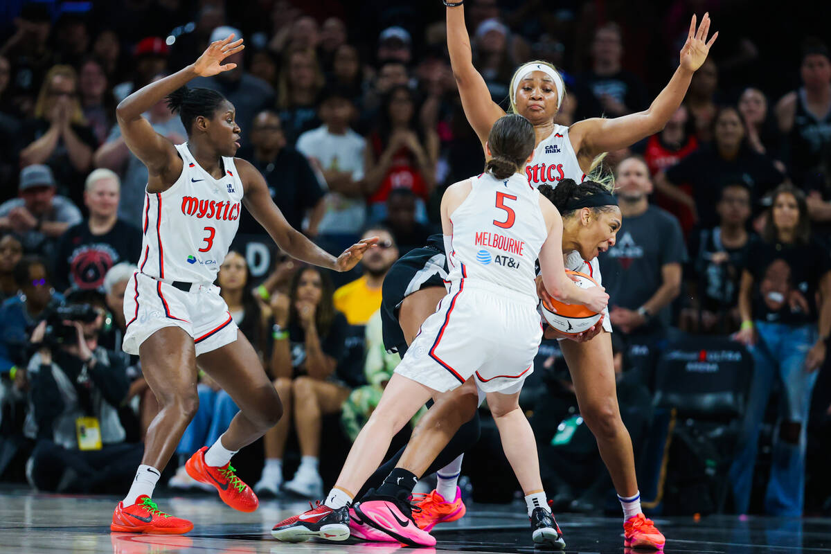 Aces center A'ja Wilson (22) struggles to moe the ball through Washington Mystics defense durin ...