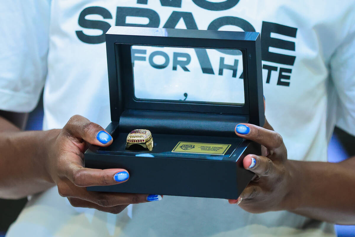 Aces guard Jackie Young holds her Olympics championship ring during a ring ceremony before a WN ...