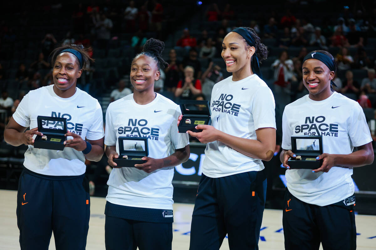 Aces teammates Chelsea Gray, from left, Jewell Loyd, A'ja Wilson and Jackie Young (0) are prese ...