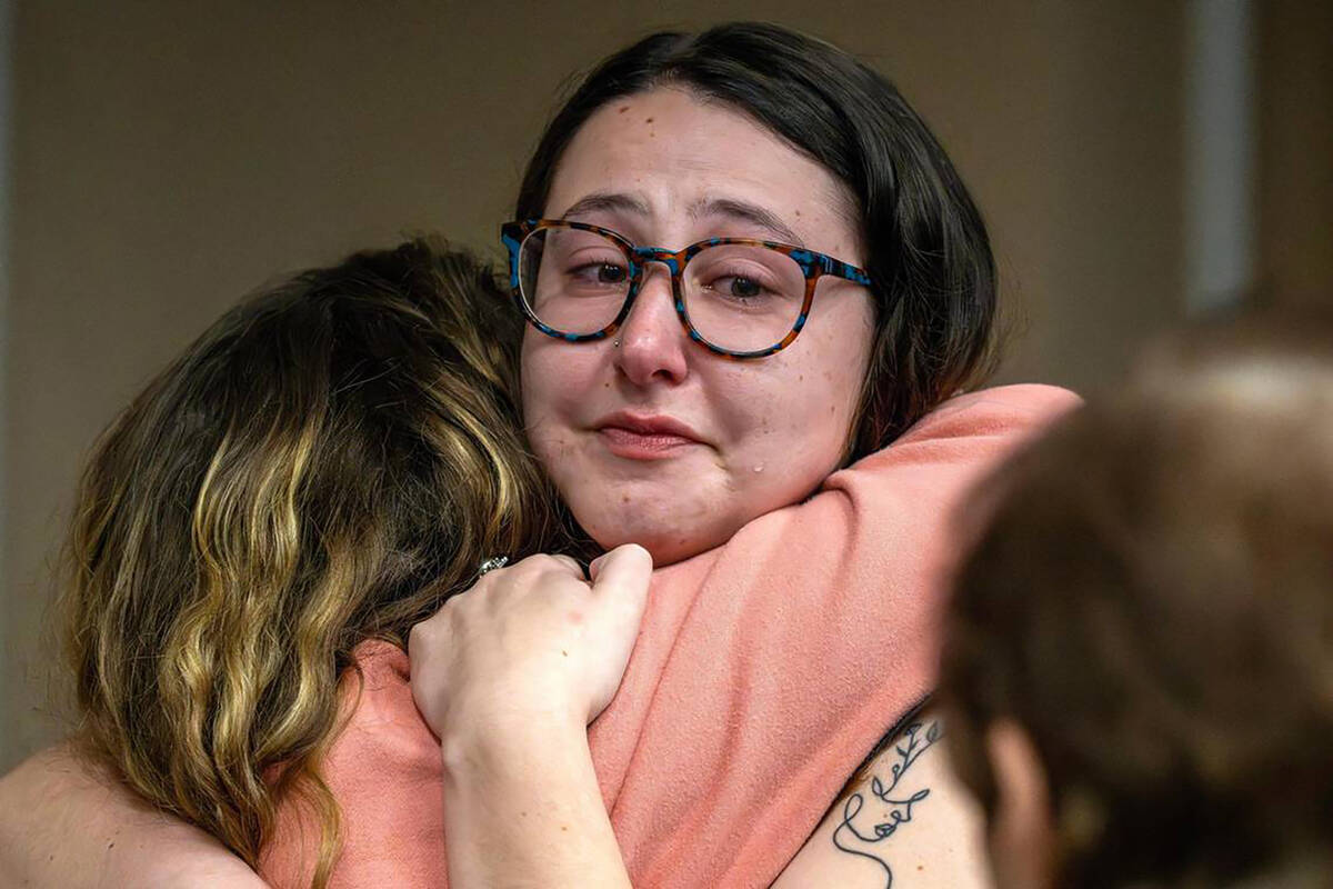 Amanda Birger, right, a close friend of Sarah Milgrim and Yaron Lischinsky, embraces her sister ...