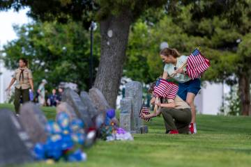 Scouting America's Kit Landman, 12, with Troop #360, and Elizabeth Landman assist with placing ...
