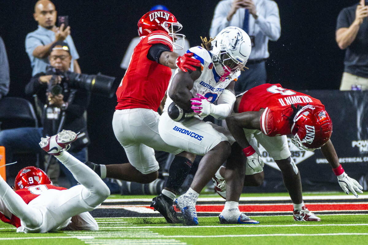 Boise State Broncos running back Ashton Jeanty (2) nearly fumbles the ball after a hit by UNLV ...