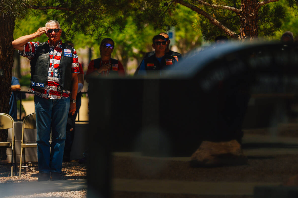 ]A veteran salutes as taps are played during a special forces ceremony in honor of Memorial Day ...