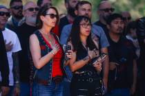 People place their hands on their hearts as the national anthem plays during a special forces c ...