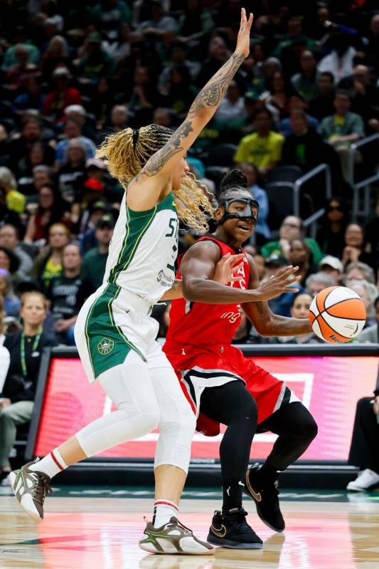Las Vegas Aces guard Jewell Loyd tries to drive on Seattle Storm forward Gabby Williams during ...