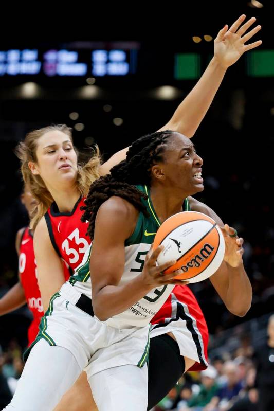 Seattle Storm forward Nneka Ogwumike spins past Las Vegas Aces center Elizabeth Kitley during t ...