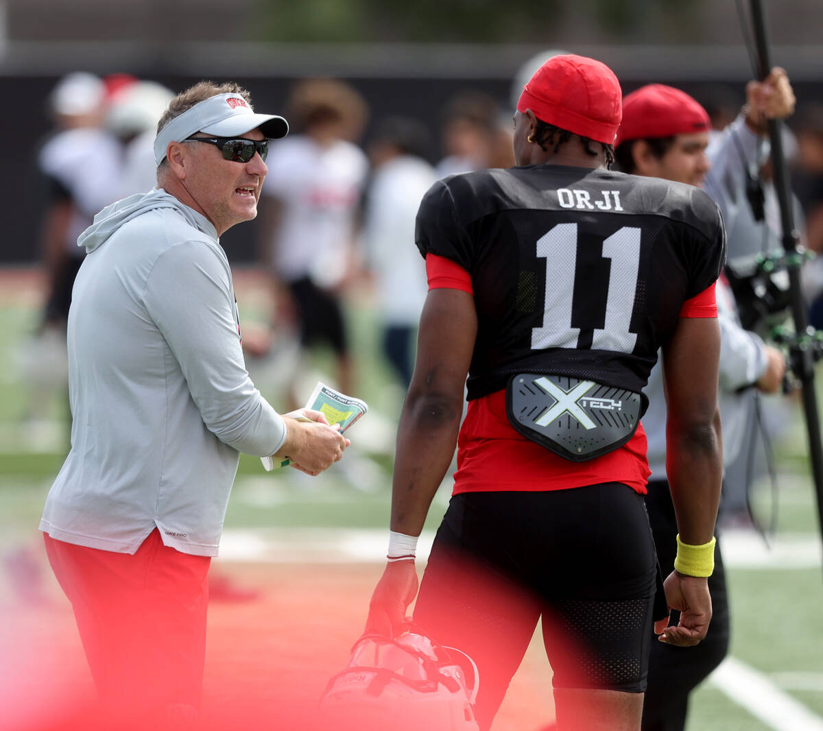 UNLV coach Dan Mullen talks to quarterback Alex Orji during a team scrimmage at Bill 'Wildcat' ...