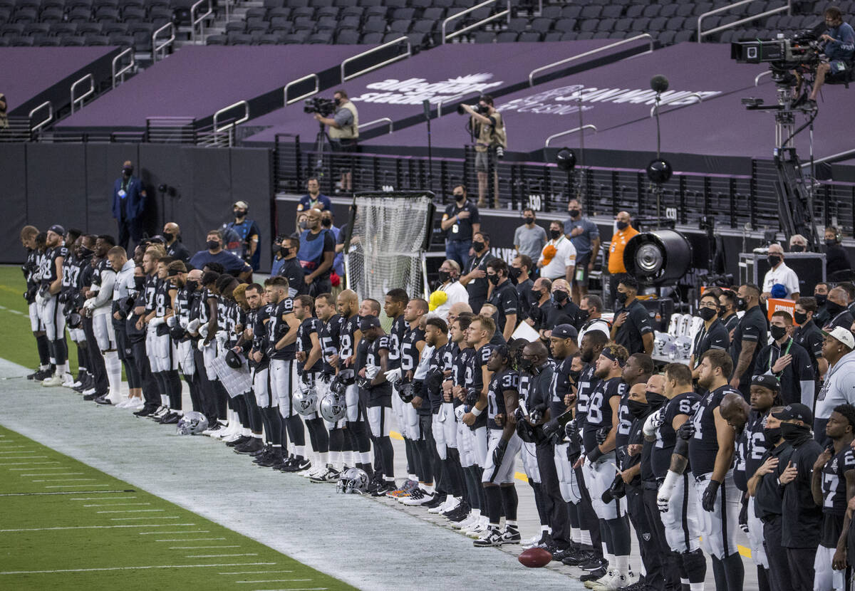 Las Vegas Raiders line up for the National Anthem before the first quarter of the Raiders home ...