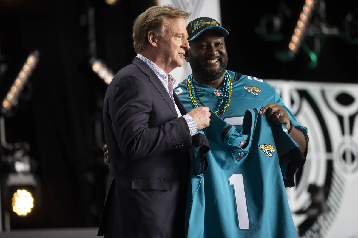 NFL Commissioner Roger Goodell, left, holds a Jacksonville Jaguars jersey after announcing Trav ...