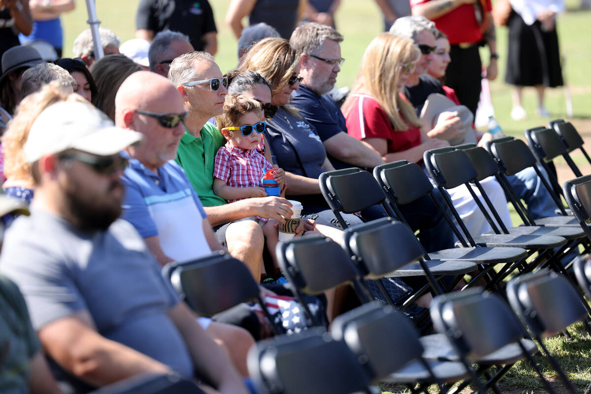 Audience members pray during the Field of Honor ceremony at Cornerstone Park in Henderson on Me ...