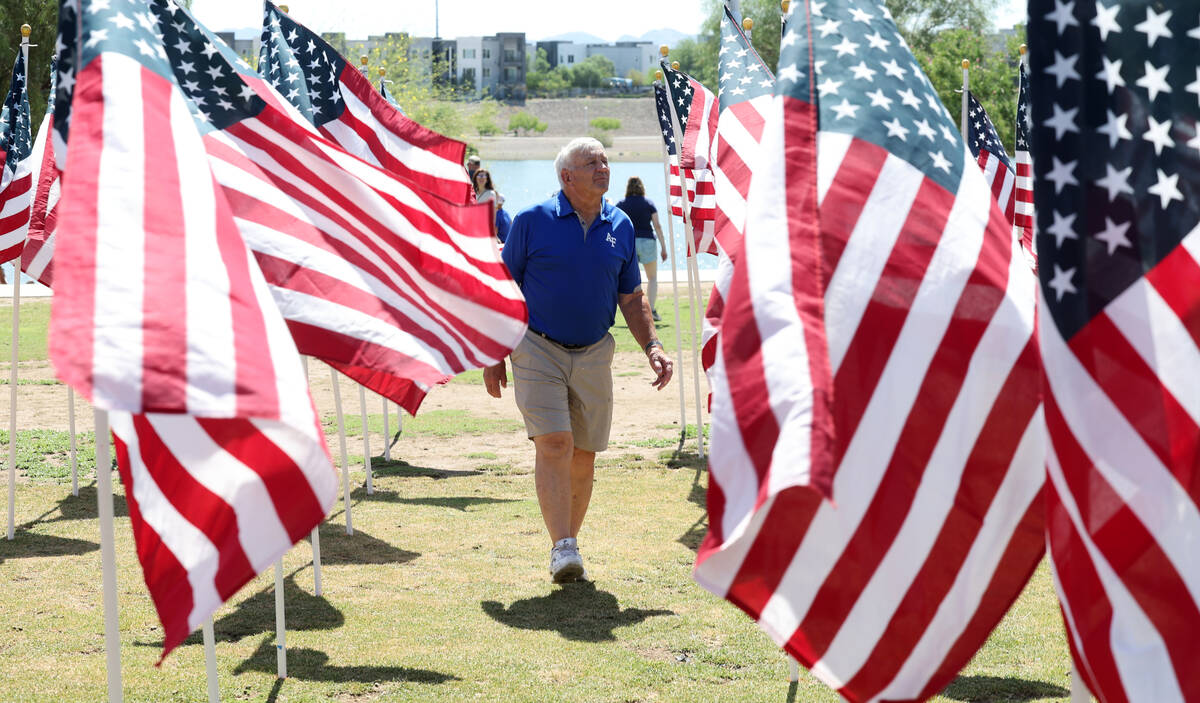 Dave Van Orsow of Henderson walks among flags during the Field of Honor ceremony at Cornerstone ...