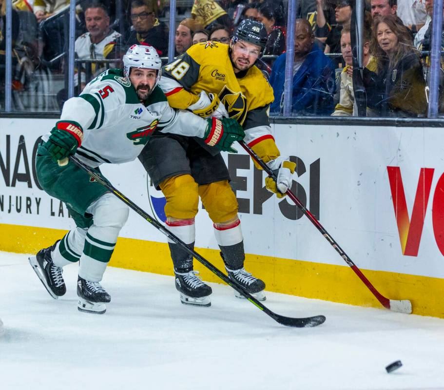 Golden Knights center Tomas Hertl (48) passes the puck with Minnesota Wild defenseman Jake Midd ...