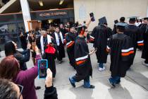 Graduating seniors at Chaparral High School are cheered on as they exit the building following ...