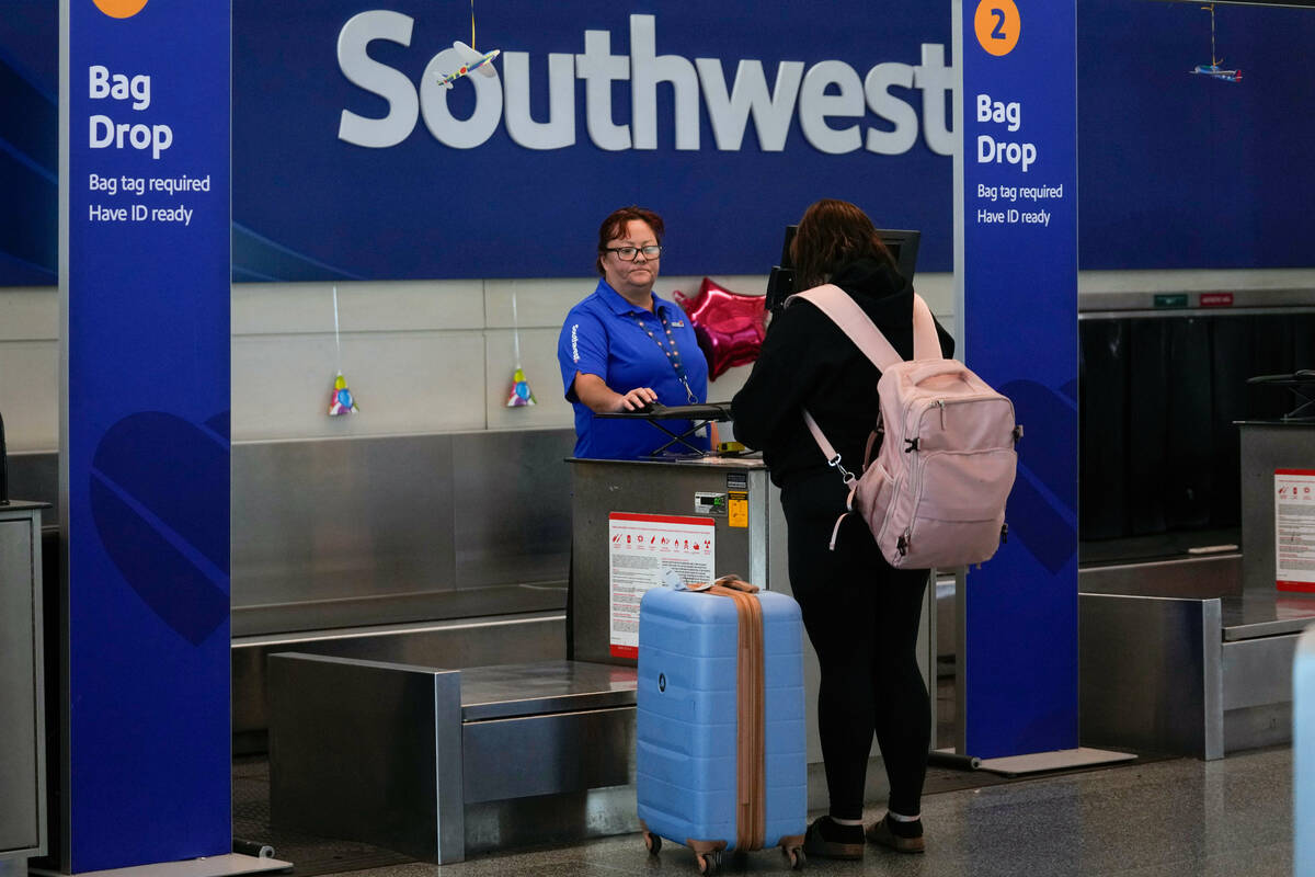 A Southwest Airlines traveler checks a bag at Midway International Airport, Tuesday, March 11, ...