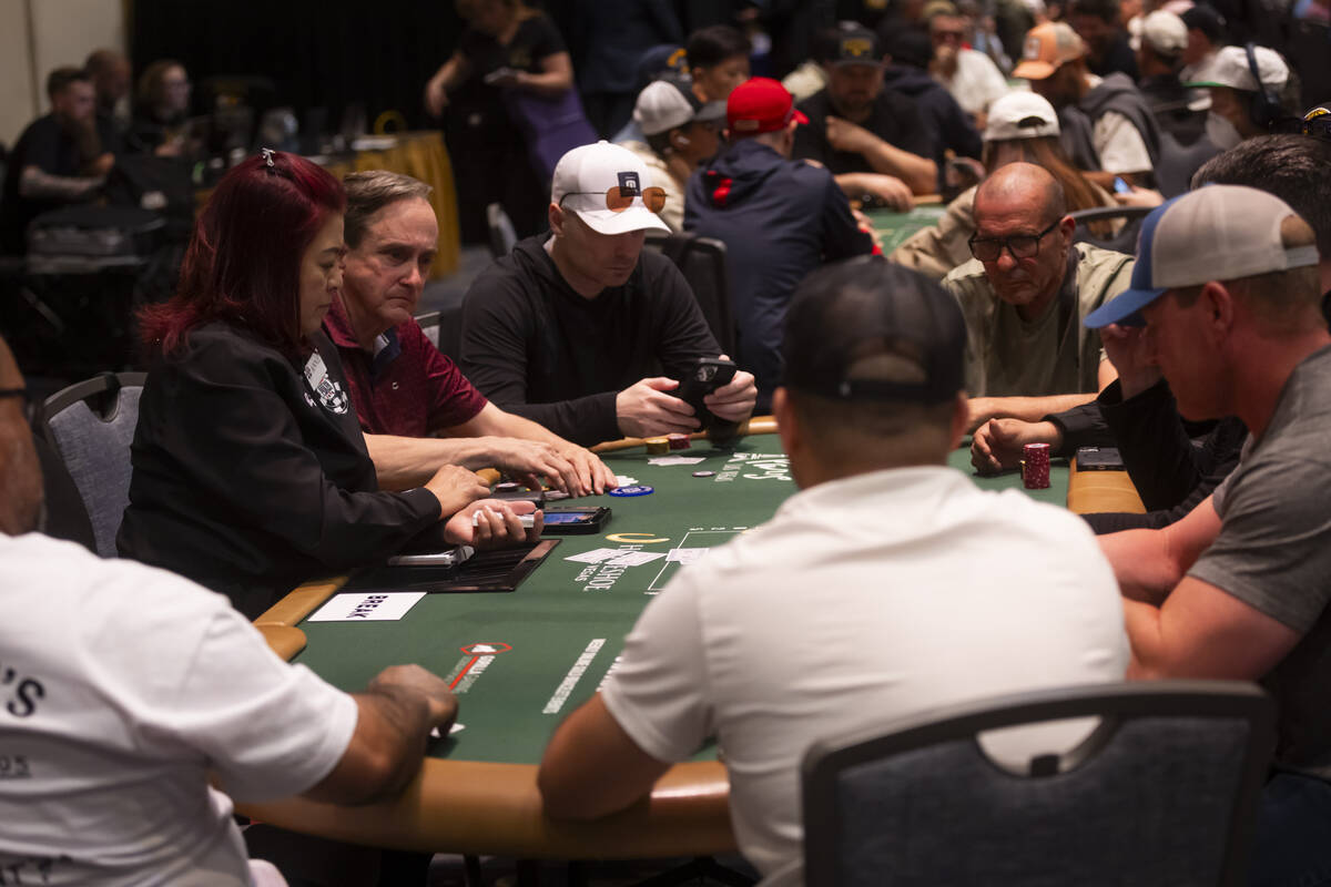 Attendees compete in the $500 industry employees no-limit hold'em event during the first day of ...