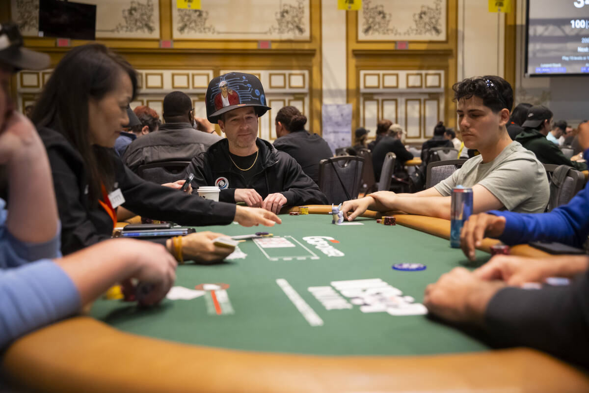 Attendees compete in the $500 industry employees no-limit hold'em event during the first day of ...