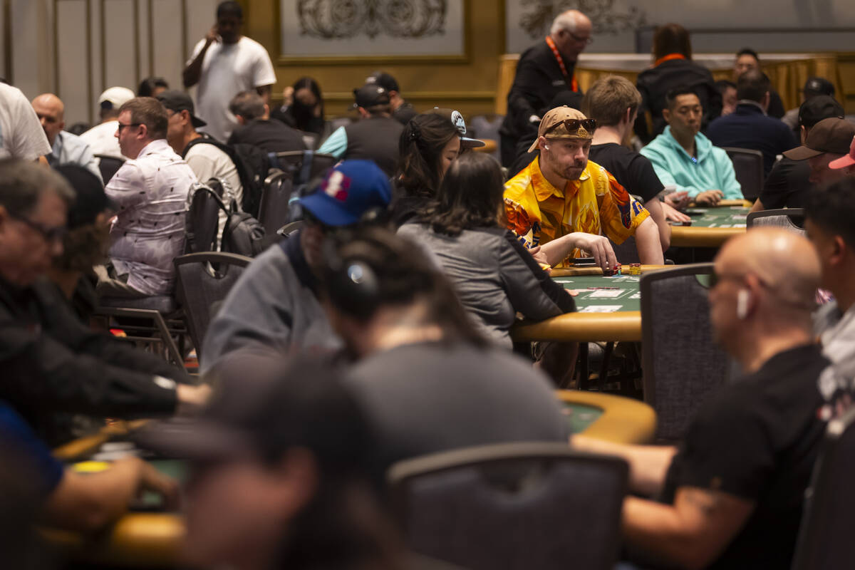 Attendees compete in the $500 industry employees no-limit hold'em event during the first day of ...