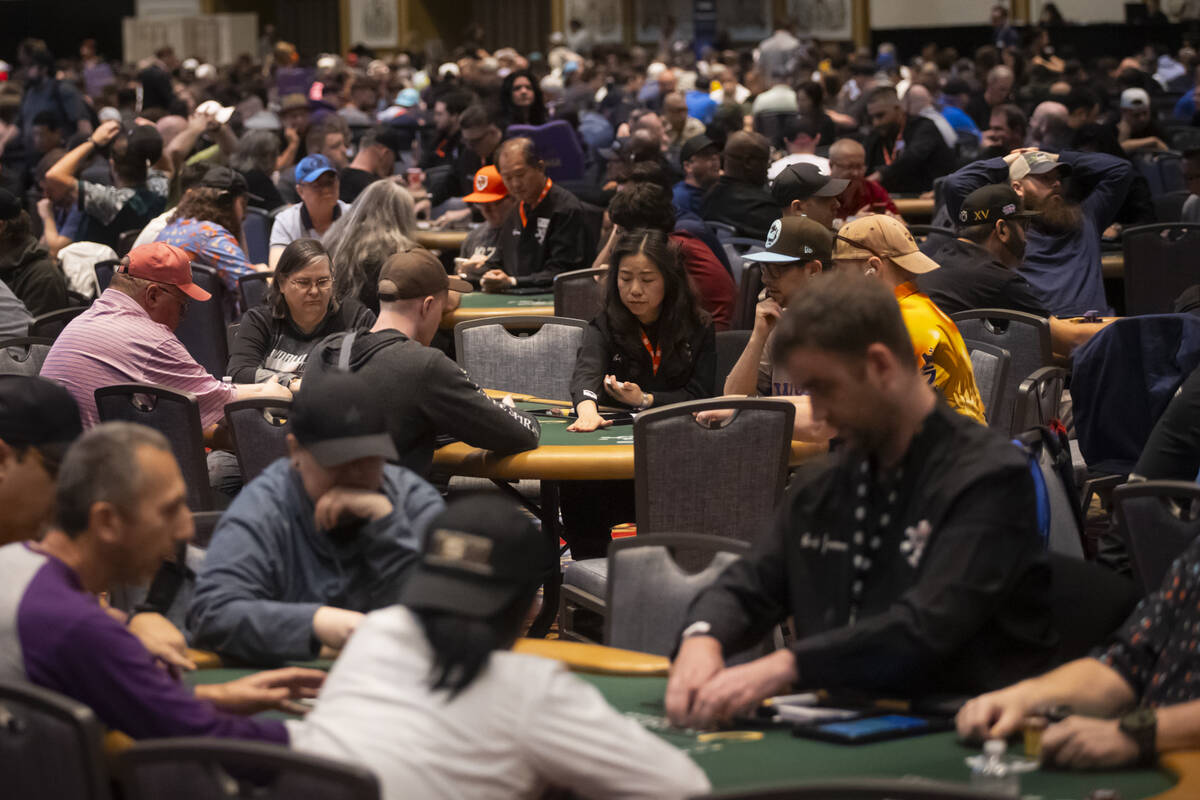 A dealer reaches for chips during the $500 industry employees no-limit hold'em event during the ...