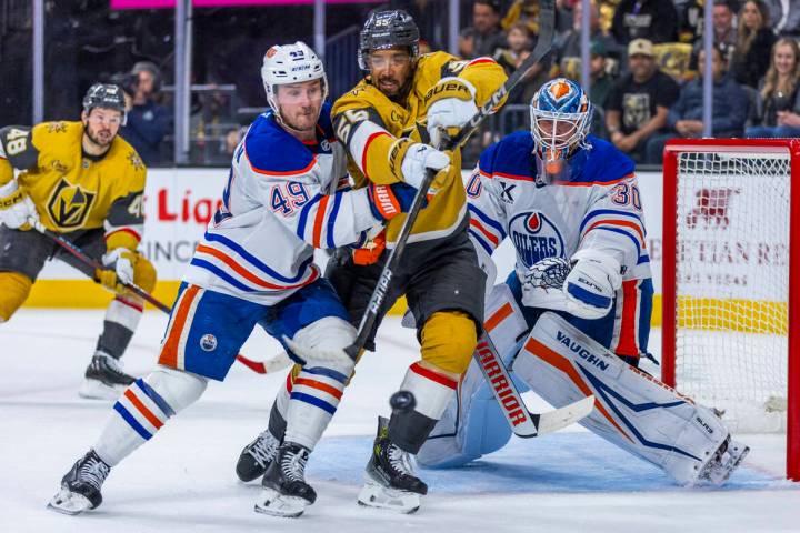 Golden Knights right wing Keegan Kolesar (55) deflects a shot past Edmonton Oilers defenseman T ...