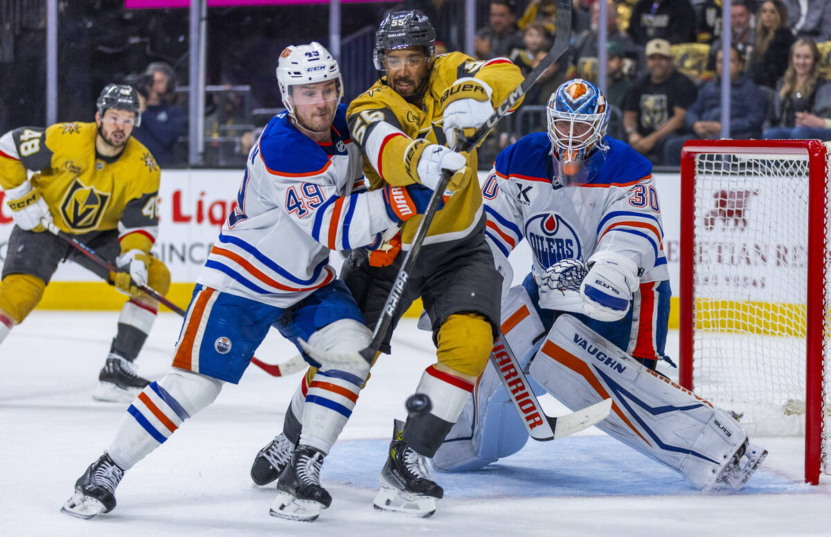 Golden Knights right wing Keegan Kolesar (55) deflects a shot past Edmonton Oilers defenseman T ...
