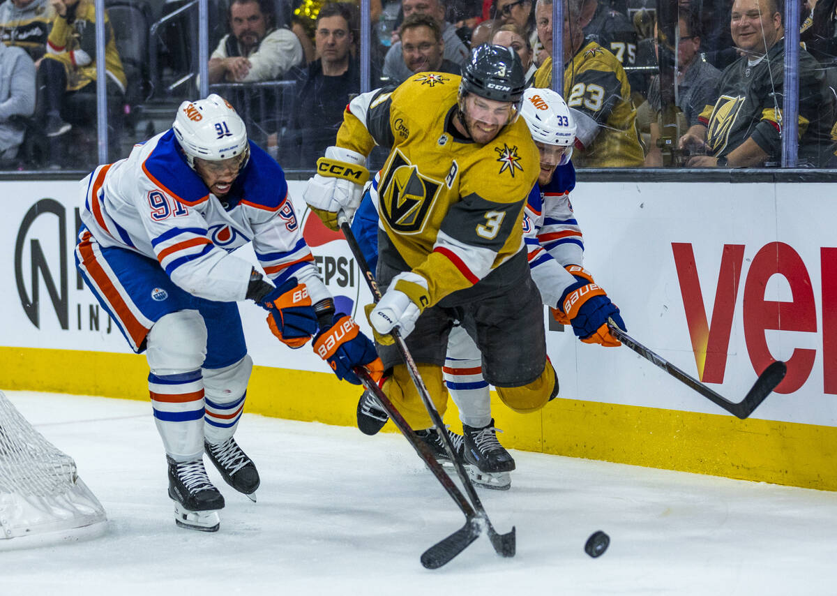 Golden Knights defenseman Brayden McNabb (3) catches some air as he keeps the puck from Edmonto ...