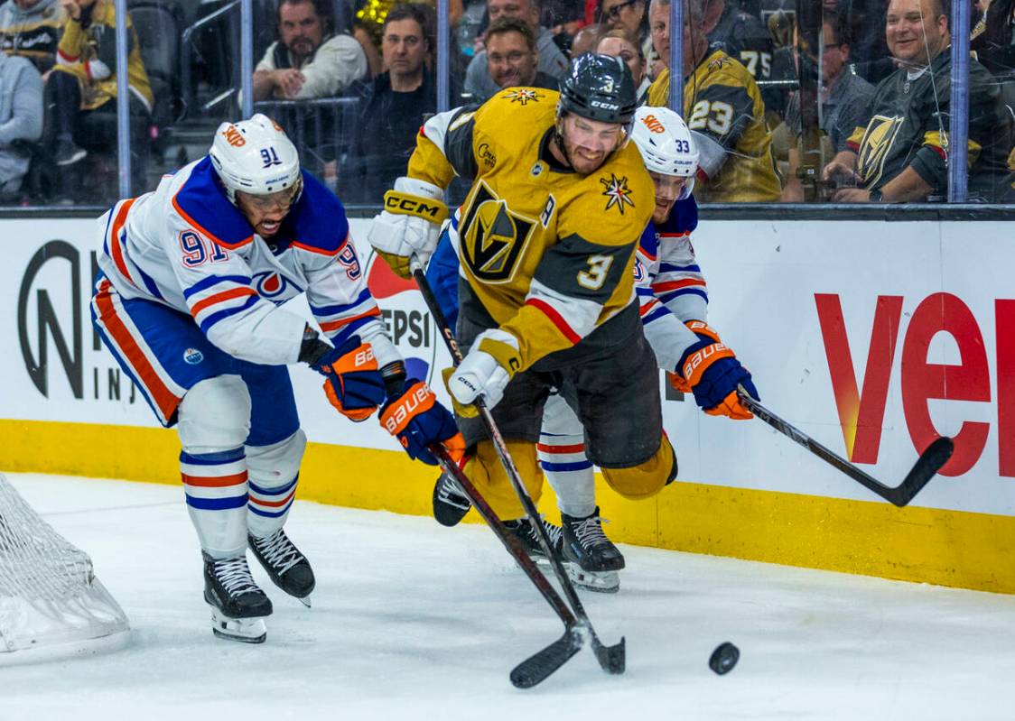 Golden Knights defenseman Brayden McNabb (3) catches some air as he keeps the puck from Edmonto ...