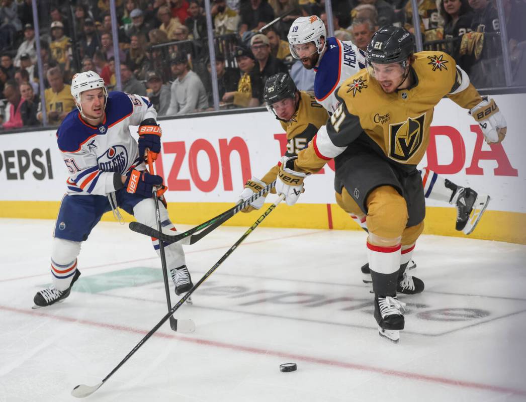 Golden Knights center Brett Howden (21) and right wing Victor Olofsson (95) battle for the puck ...