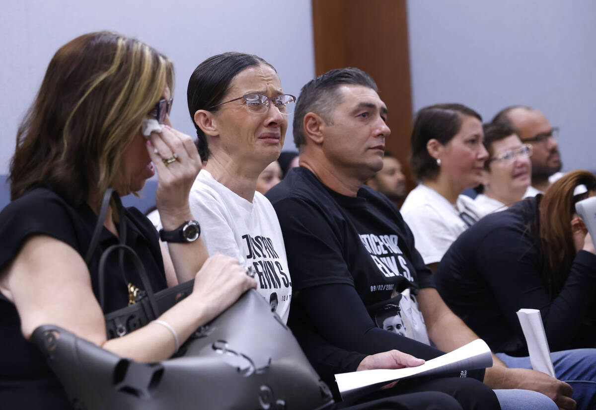 Velida Husic, second left, Alen Sejdinovic, center, parents of a shooting victim, Elvin Sejdino ...
