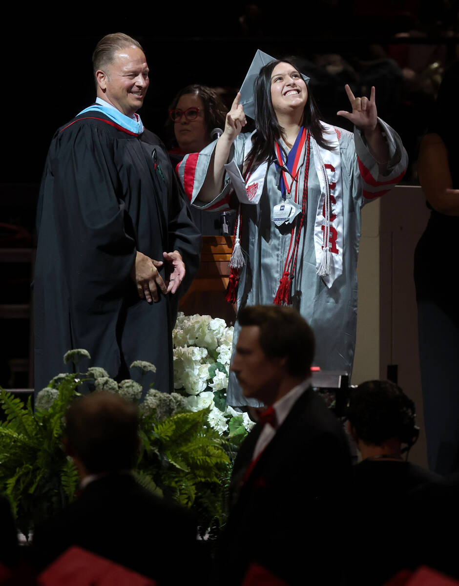 Arbor View High School students walk across the stage during graduation at the Thomas & Mac ...