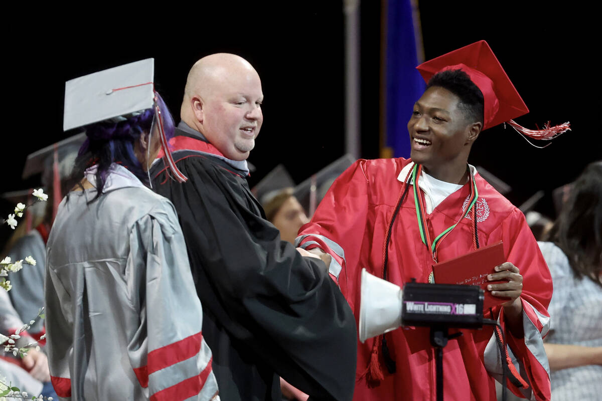 Arbor View High School students receive their diplomas during graduation at the Thomas & Ma ...