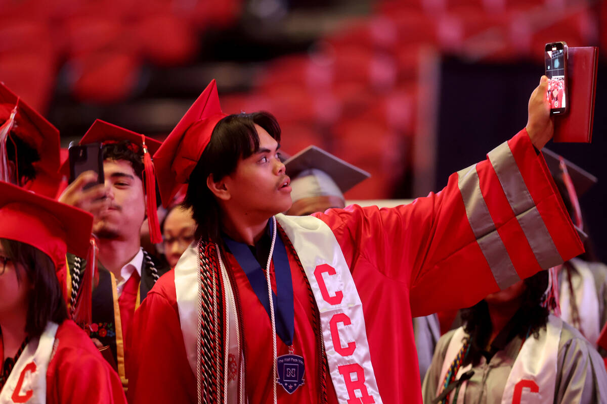 Arbor View High School students celebrate after receiving their diplomas during graduation at t ...
