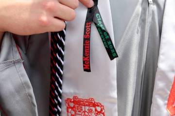 An Arbor View High School student dons a ribbon honoring classmate McKenzie Scott after gradua ...