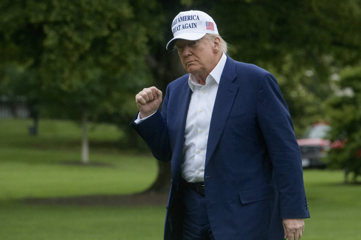 President Donald Trump acknowledges reporters as he disembarks Marine One upon arrival on the S ...