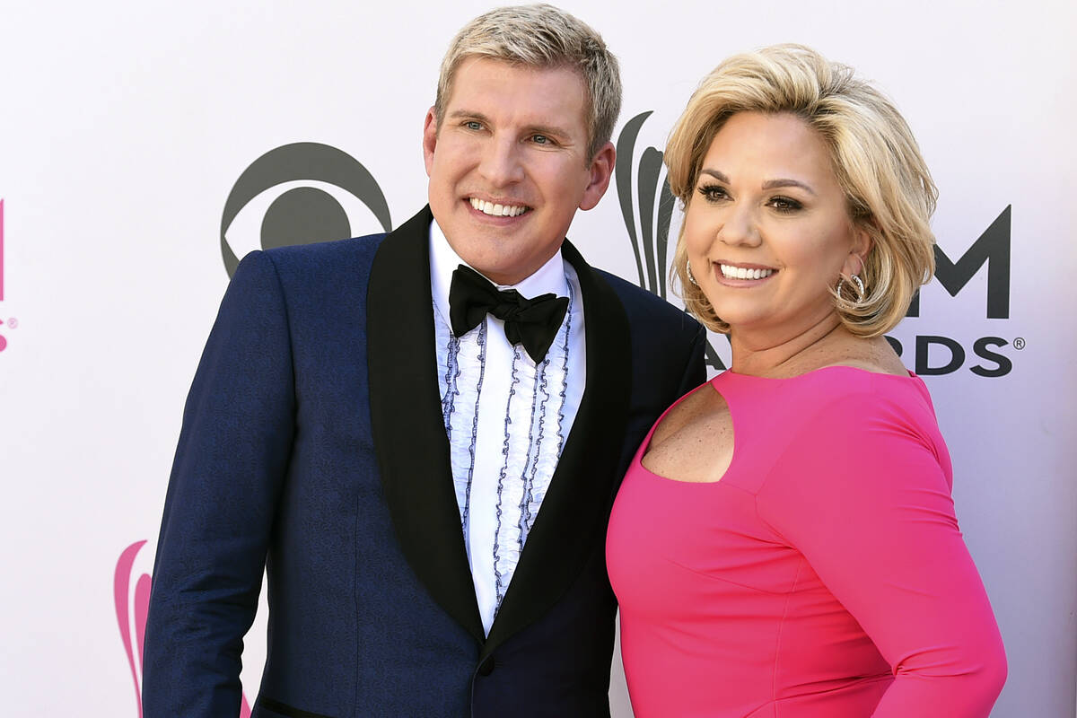 Julie Chrisley, right, and her husband Todd Chrisley pose for photos at the 52nd annual Academy ...