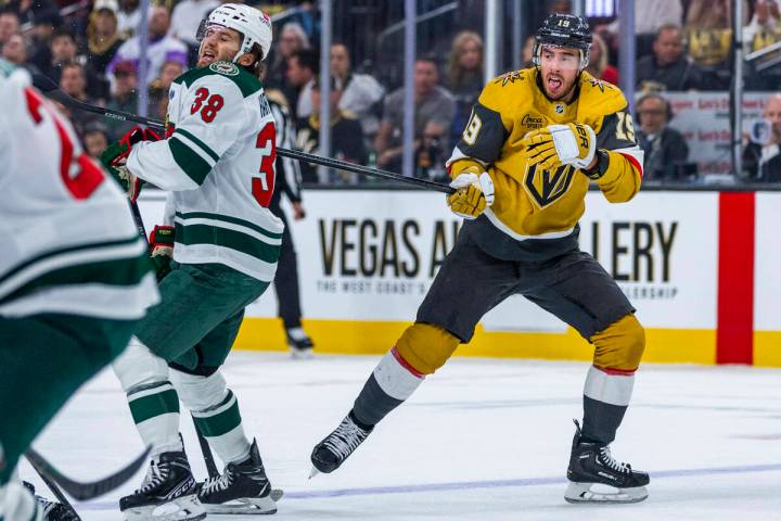 Golden Knights right wing Reilly Smith (19) has his stick held by Minnesota Wild right wing Rya ...