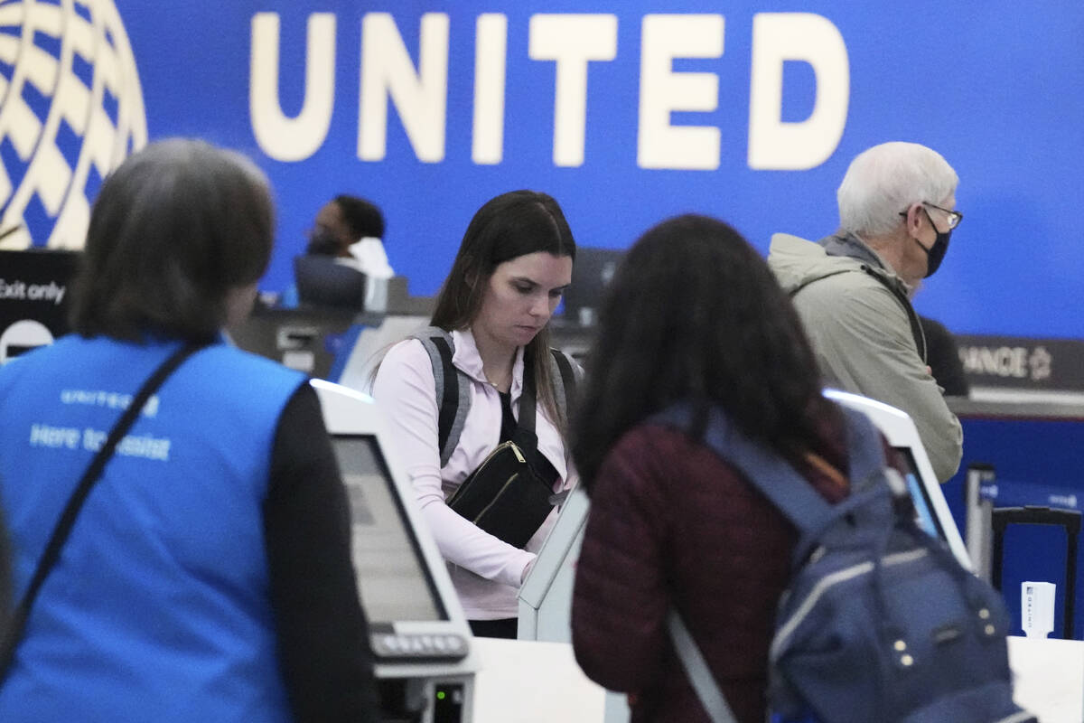 Travelers print their boarding passes at kiosks inside of O'Hare International Airport in Chica ...