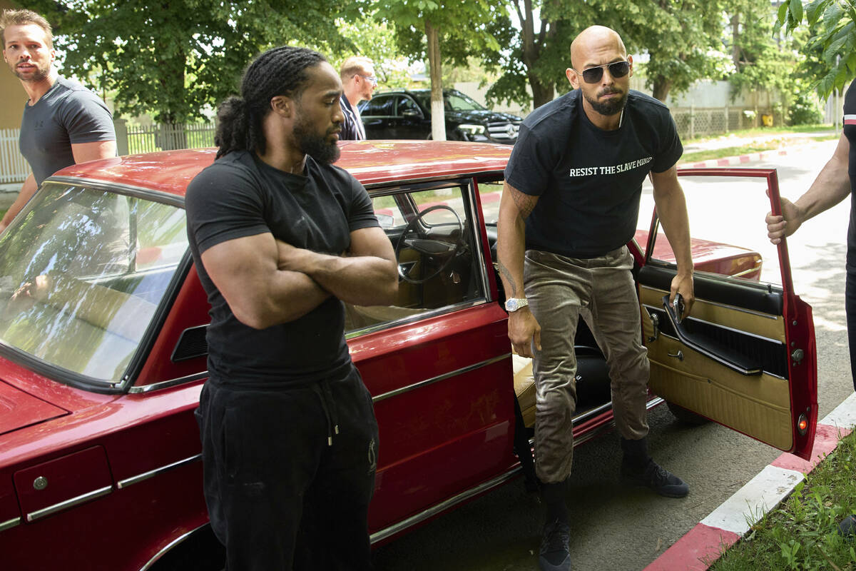 Andrew Tate and his brother Tristan, top left, arrives at a police station in a Lada vehicle in ...