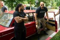 Andrew Tate and his brother Tristan, top left, arrives at a police station in a Lada vehicle in ...